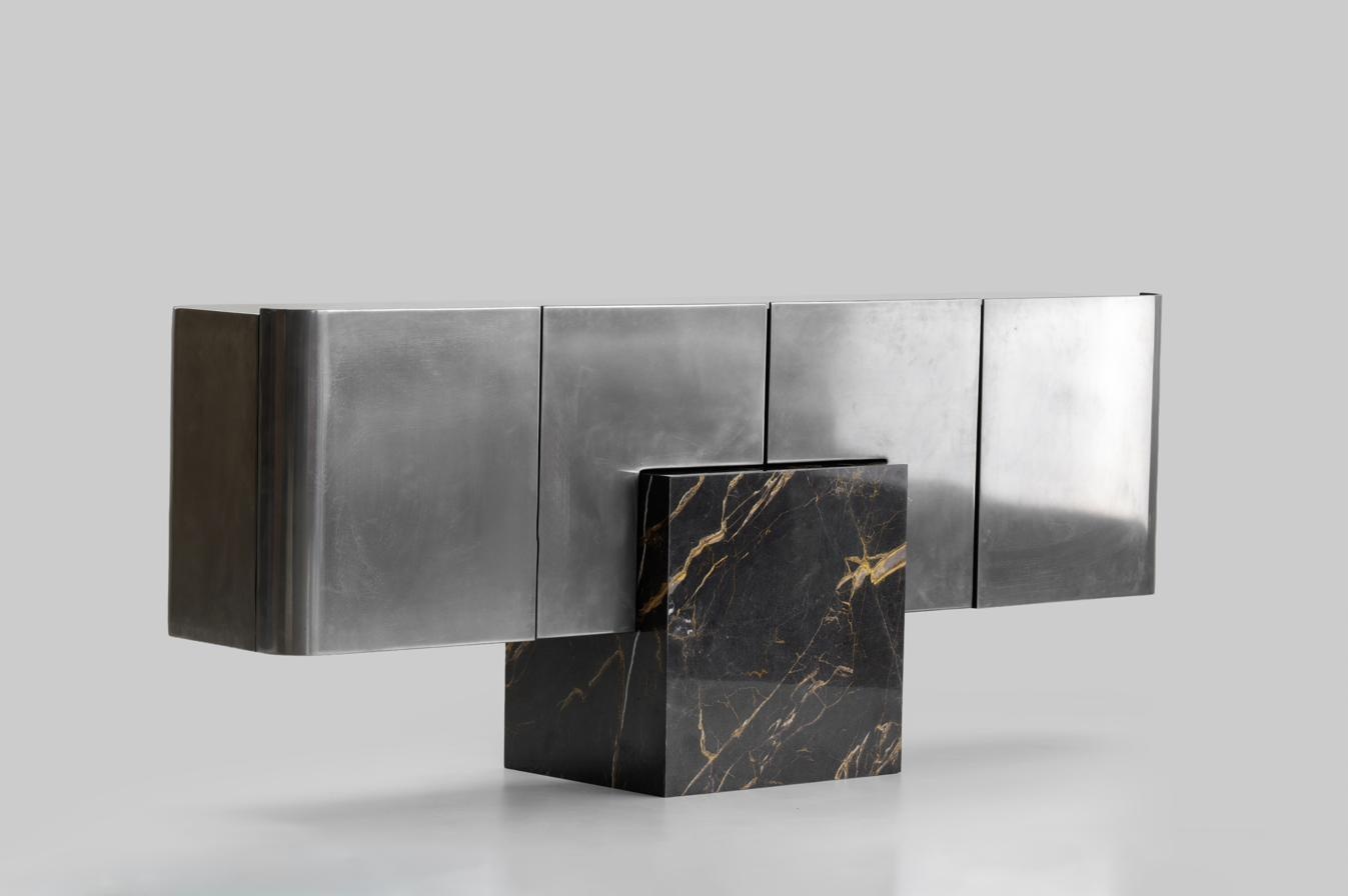 Liquid Metal Console — flowing metal form on marble base