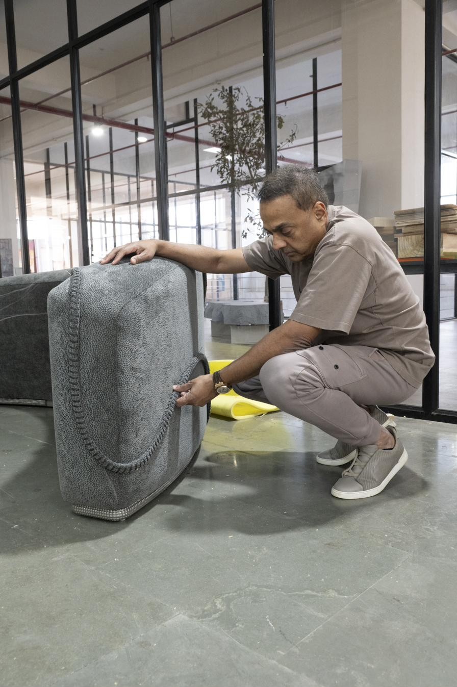 Close view of the sculptural lounge piece, showing hand-stitched detail